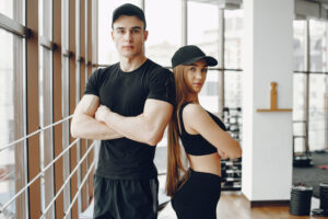 man and woman standing at gym.