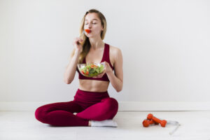 Woman eating foods after a workout for recovery.