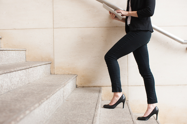 Woman taking the stairs at her work.