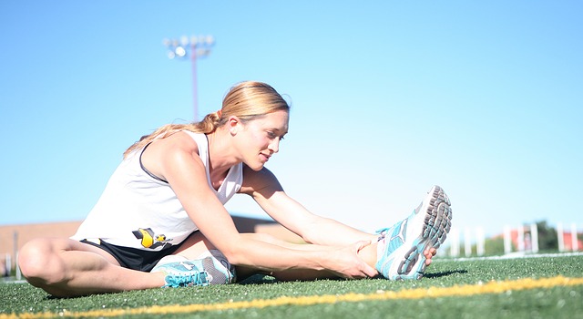 woman stretching on a sports field.