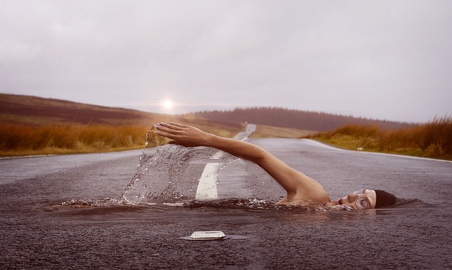 woman swimming, but appears on a road instead.