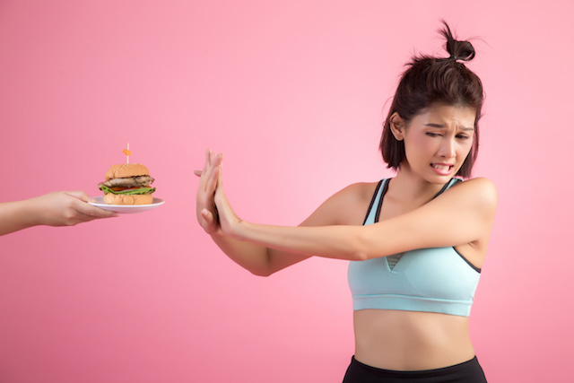 woman refusing food after a workout.