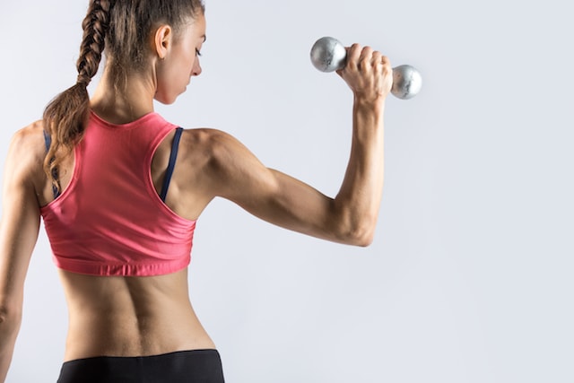 woman lifting arm weights. 