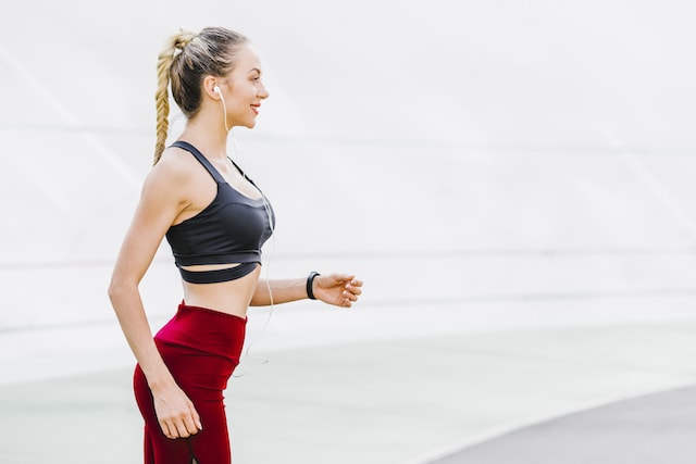 woman wearing safe form fitting running clothes and a braid.