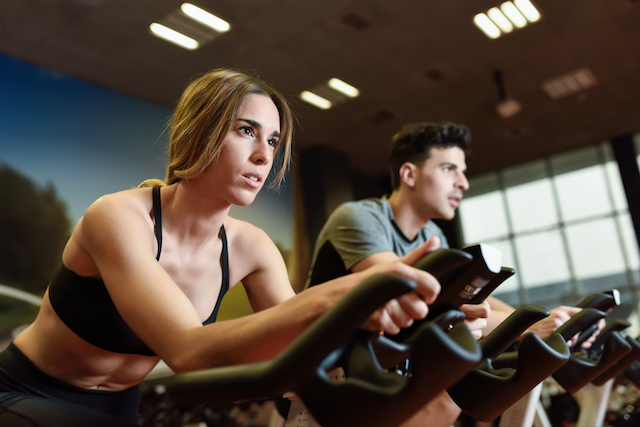 woman and man in a spinning class.