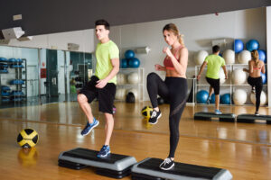 woman and male in a step class