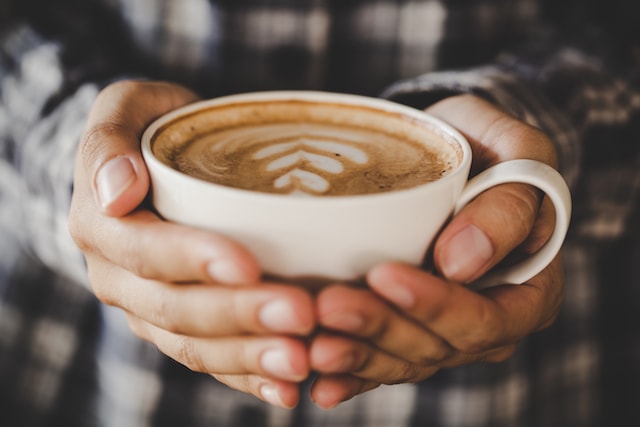 hands holding a cup of coffee.