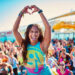woman making a heart with her hands while dancing zumba.
